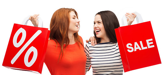 Image showing two smiling teenage girl with shopping bags