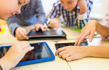 Image showing close up of school kids playing with tablet pc 