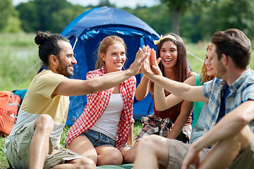 Image showing happy friends making high five at camping