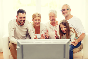 Image showing happy family watching tv at home