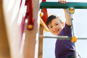 Image showing happy little boy climbing on children playground