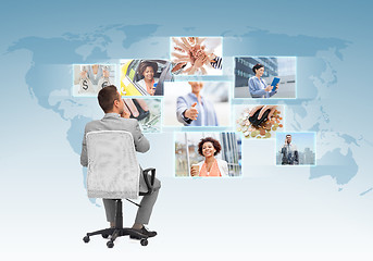 Image showing businessman sitting in office chair from back