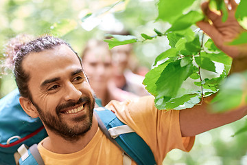 Image showing group of smiling friends with backpacks hiking