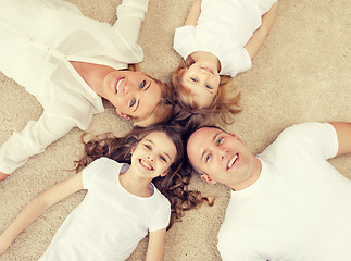 Image showing parents and two girls lying on floor at home