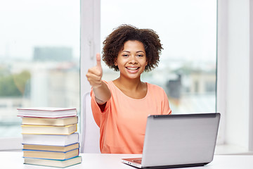 Image showing happy african american woman with laptop at home