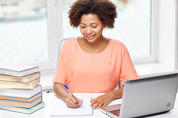 Image showing happy african american woman with laptop at home