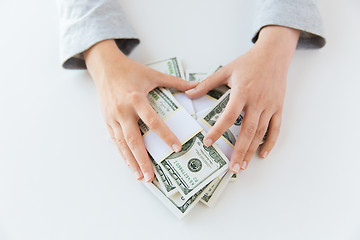 Image showing close up of woman hands counting us dollar money