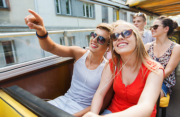 Image showing happy teenage couple traveling by tour bus