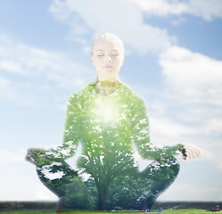 Image showing happy young woman doing yoga outdoors