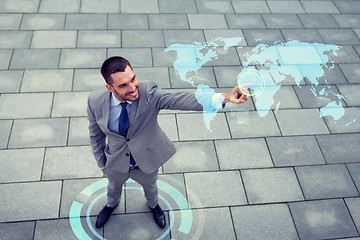 Image showing smiling businessman with world map projection