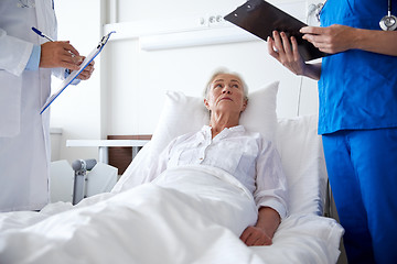 Image showing doctor and nurse visiting senior woman at hospital