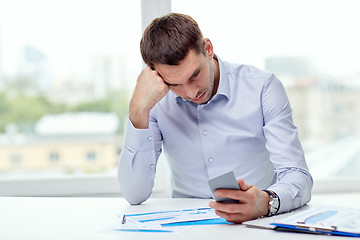 Image showing close up of businessman with smartphone