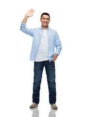 Image showing smiling man waving hand