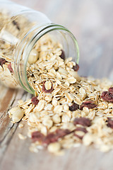 Image showing close up of jar with granola or muesli on table