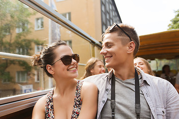 Image showing smiling couple traveling by tour bus