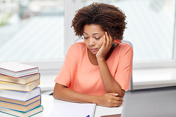 Image showing bored african american woman doing homework home