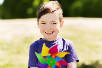 Image showing happy little boy with colorful pinwheel at summer