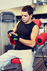 Image showing young man with smartphone in gym