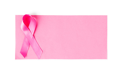 Image showing close up of pink cancer awareness ribbon on paper