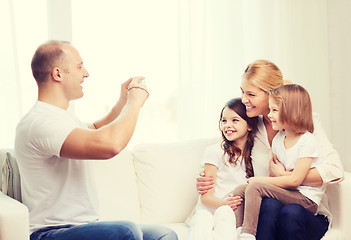 Image showing father taking picture of mother and daughters