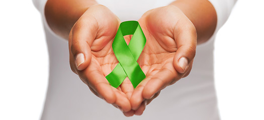 Image showing hands holding green awareness ribbon