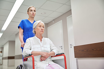 Image showing nurse with senior woman in wheelchair at hospital