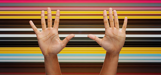 Image showing two african hands making high five over blue sky