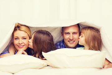 Image showing two little girls kissing their parents on cheek