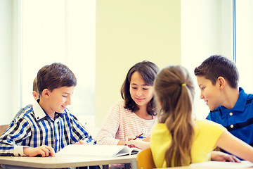 Image showing group of school kids writing test in classroom