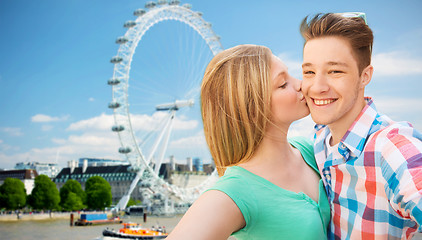 Image showing happy couple taking selfie over london