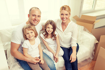 Image showing smiling parents and two little girls at new home