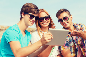 Image showing group of smiling friends with tablet pc outdoors