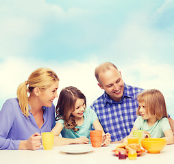 Image showing happy family with two kids with having breakfast