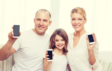 Image showing parents and little girl with smartphones at home