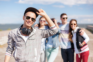 Image showing teenage boy with sunglasses and friends outside