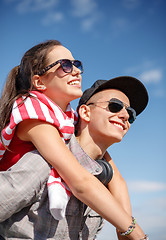 Image showing smiling teenagers in sunglasses having fun outside