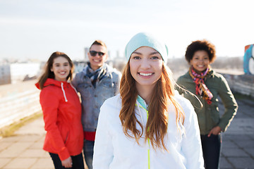 Image showing group of happy teenage friends on city street