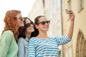 Image showing smiling young women taking selfie with smartphone