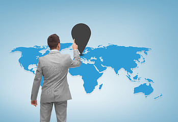 Image showing businessman pointing finger to mark on world map