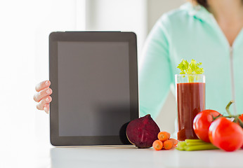 Image showing close up of woman with tablet pc and vegetables