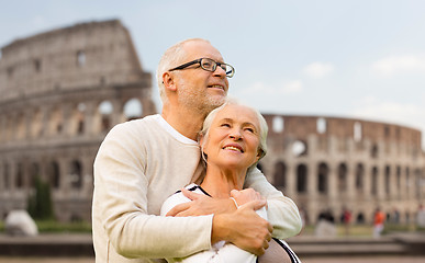 Image showing happy senior couple over coliseum in rome, italy