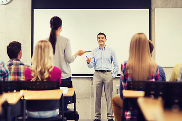 Image showing group of students and smiling teacher in classroom