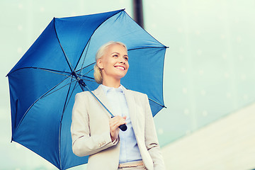 Image showing young smiling businesswoman with umbrella outdoors