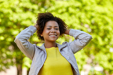 Image showing happy african american young woman in summer park