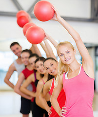 Image showing group of smiling people working out with ball