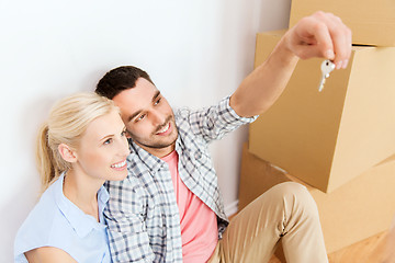 Image showing couple with key and boxes moving to new home