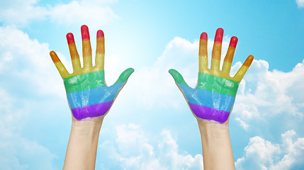 Image showing palms of human hands painted in rainbow colors