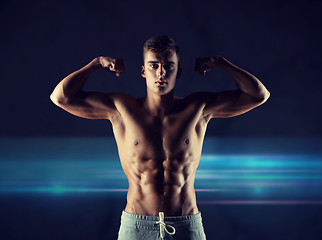 Image showing young man showing biceps and muscles