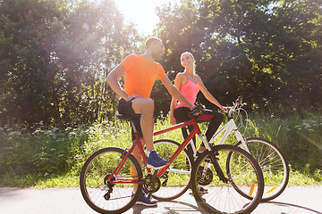 Image showing happy couple riding bicycle outdoors