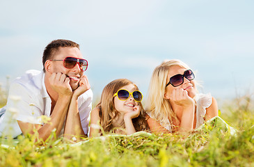 Image showing happy family with blue sky and green grass